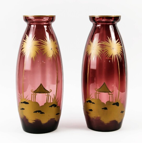 Pair of large vases, early 20th century, round stand, ovoid body, with flared rim, violet glass with gold staffage, landscape with palm trees, partly min. chipped, h. 41.5 cm