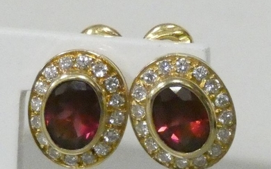 Pair of yellow gold earrings centered with oval...