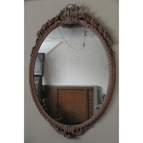 Regency style oval wall mirror with ornate foliate, scroll a...
