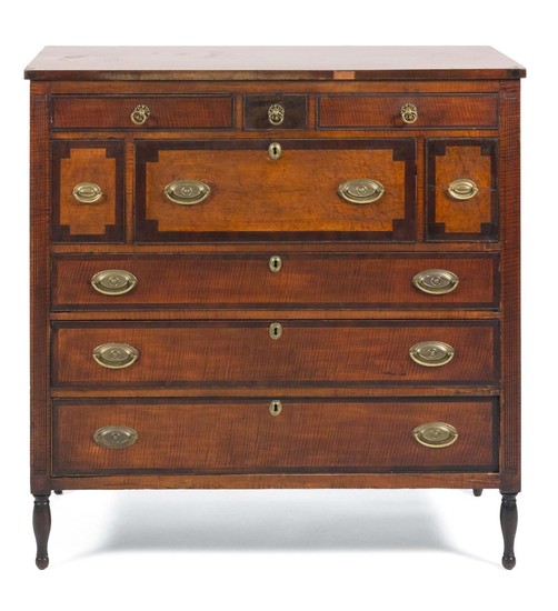 SHERATON TALL CHEST In cherry with bird's-eye and tiger maple veneer. Two tiers of three side-by-side drawers of varied sizes over t..