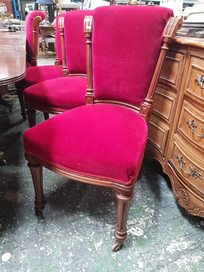 Set of 12 Late Victorian Mahogany Dining Chairs, the scrolled and columned backs upholstered in red velvet & on turned fluted legs