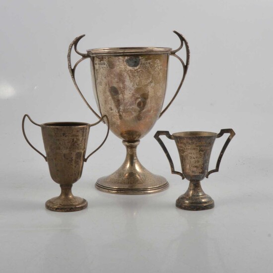 Silver two-handled trophy cup, Stevenson & Law, Sheffield 1917, and two small plated trophy cups.