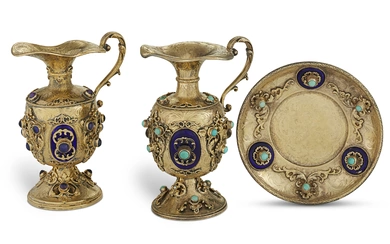 TWO SIMILAR CONTINENTAL ENAMEL AND SILVER-GILT GEM-MOUNTED EWERS AND A STAND MAKER'S MARK HK, PROBABLY AUSTRIA, CIRCA 1900