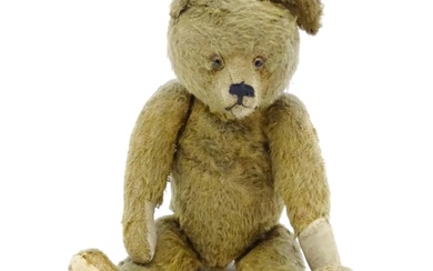Toy: An early 20thC mohair straw filled teddy bear with prou...