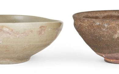 Two Chinese stoneware bowls, Song-Yuan dynasty, one covered in a thick celadon glaze, the other covered in a brown glaze stopping short of the foot, 11.8cm-14.2cm diameter (2) Provenance: The celadon bowl with a 'Mary and Peter White Collection'...