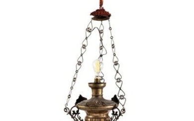 Votive lamp in silver metalRome, 20th centurysmooth baluster body decorated with volutes and applied leaves, mounted with electric light h 72 cm