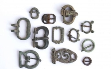 Group of twelve bronze belt buckles Medieval; length max cm...