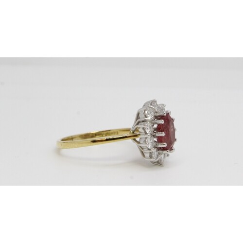 18ct gold oval ruby and diamond cluster ring. Diamonds 1,00c...