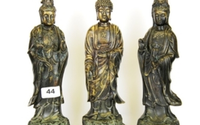 A cast bronze figure of the standing Buddha flanked by two Guanyin, H. 29cm.