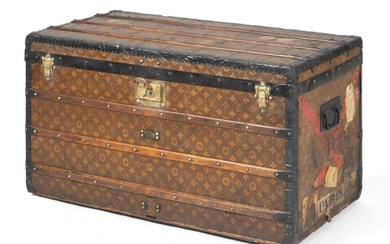 LOUIS VUITTON STEAMER TRUNK Exterior with allover LV monograms, beechwood slats, brass locks, and metal handles and hardware. Sides...