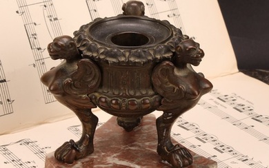 A 19th century brown patinated bronze tripod inkwell, cast i...