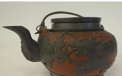 A 19thC Chinese Yixing red clay teapot of squat, bulbous for...