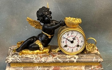 A 20th century French style gilt-metal and bronzed mantel cl...