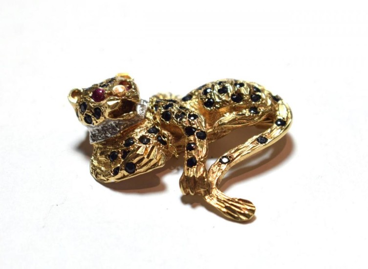 A 9 carat gold gem set brooch in the form...