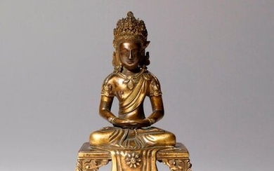 A CHINESE GILT-BRONZE FIGURE OF AMITAYUS 18TH CENTURY He sits...