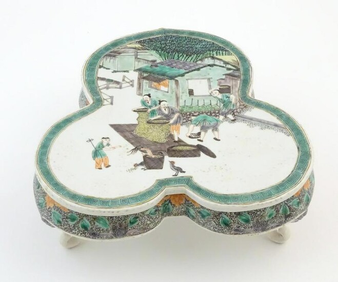 A Chinese famille verte stand of trefoil form depicting
