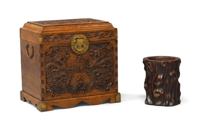A Chinese huali brushpot and travel chest, guanpixiang, late Qing dynasty, the brush pot carved to simulate a tree trunk, 17cm high, the chest carved with a pair of dragons to the front and a front facing dragon to the top, with brass hardware...
