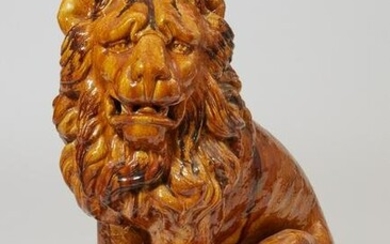 A Continental earthenware seated lion