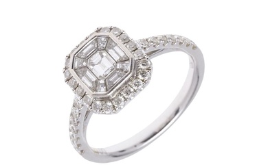A DIAMOND CLUSTER RING. the octagonal-shaped central diamond...
