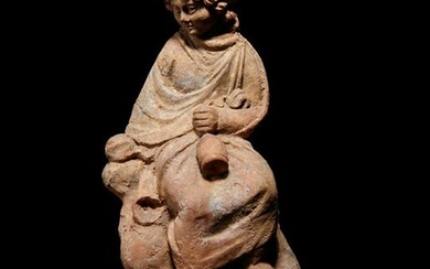 A Greek Terracotta Seated Scholar Holding a Wine Jug