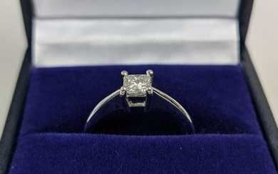 A PLATINUM DIAMOND SOLITAIRE RING, the single princess cut s...