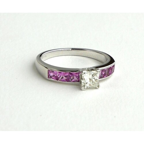 A PLATINUM RING SET WITH CENTRAL PRINCESS CUT DIAMOND ON PIN...