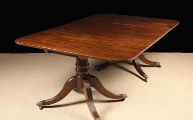 A Regency Mahogany Twin Pedestal Dining Table. The two D-end sections standing on turned pedestal wi