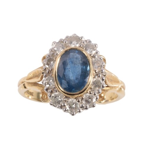 A SAPPHIRE AND DIAMOND CLUSTER RING the oval-cut sapphire co...