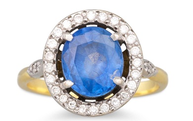 A SAPPHIRE AND DIAMOND RING, the oval sapphire to a...