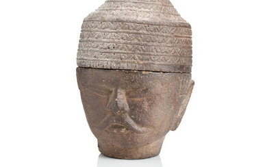 A SOUTH EAST ASIAN CARVED GREY STONE HEAD