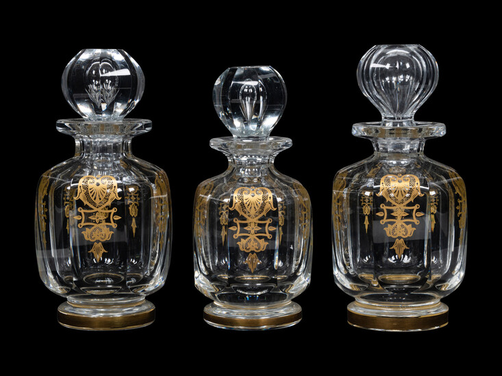 A Set of Three Baccarat Glass Decanters with Gilt Decoration