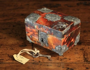 A Small 17th Century Antwerp Casket with Tortoiseshell Veneers(A/F). The rectangular box having a slightly domed lid adorned with decorative pewter mounts cast with female busts, and a lock & key to the front, raised on small bun feet 2½ in (6 cm)