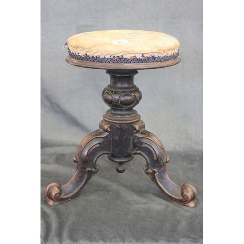A Victorian and ebonised piano stool, with circular adjustab...