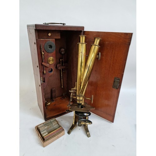 A Victorian brass binocular microscope, with a box of slides...
