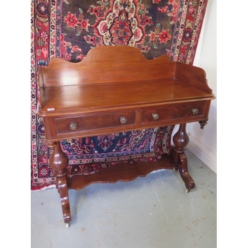 A Victorian mahogany two drawer wash stand with a gallery an...