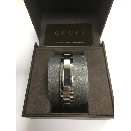 A boxed Gucci bangle watch.