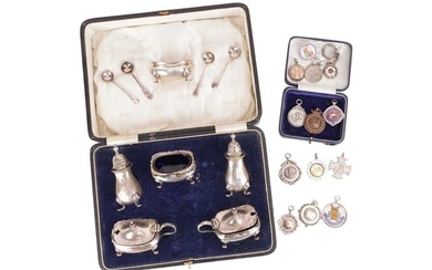 A boxed set of silver pepperettes, mustards with spoons and salts with blue glass liners, hallmarked