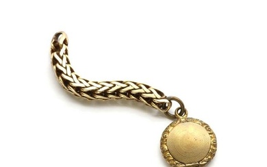 A circular gilt metal locket
