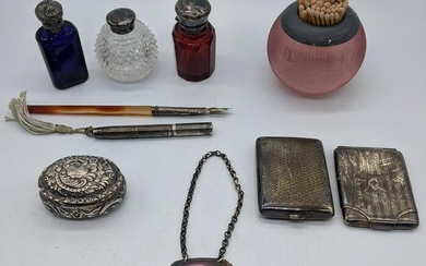 A collection of silver items to include a glass