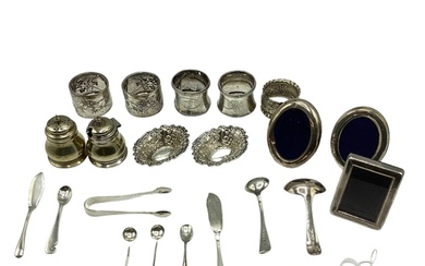 A collection of sterling silver items to include napkin ring...