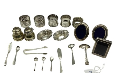 A collection of sterling silver items to include napkin...