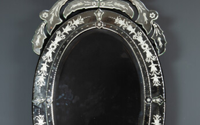 A contemporary Venetian style oval wall mirror