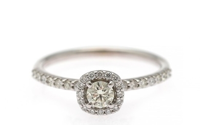 A diamond ring set with a brilliant-cut diamond flanked by numerous diamonds weighing a total of app. 0.50 ct., mounted in 14k white gold. Size 52.