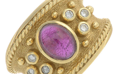 A garnet cabochon dress ring, with brilliant-cut diamond accents.