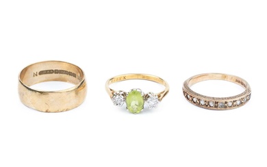 A green stone and diamond three stone ring, the oval...