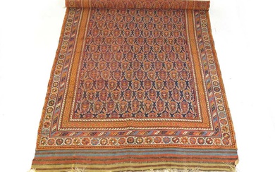 A handwoven Persian rug, possibly Kashan, the multi line border...