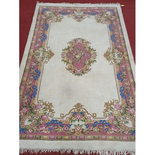 A large Cream ground Carpet with pink and blues. 278 x 183cm...