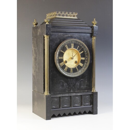 A late 19th century French slate mantel clock, the architec...