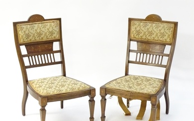 A pair of Edwardian walnut side chairs with satinwood marque...