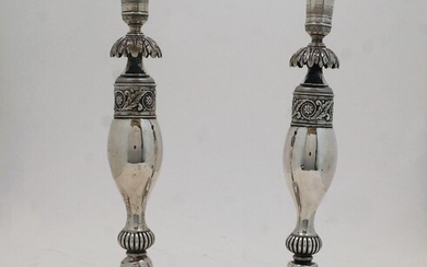 A pair of German candlesticks, Berlin, c.1830, by Georg Friedrich Fournier, with urn surmount above baluster stems with acanthus leaf and foliate decoration on square base, approx. 30.5cm, total weight approx. 21.8oz (2)